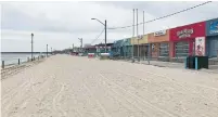  ?? BETSY POWELL TORONTO STAR ?? Wasaga Beach, normally packed on a long weekend, was eerily empty on Sunday afternoon as attraction­s remain closed.