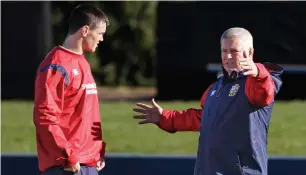  ?? AP ?? British and Irish Lions head coach Warren Gatland with reserve flyhalf Johnny Sexton during a training session. —