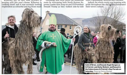  ?? Photo by Christy Riordan ?? Colin O’Brien, wolfhound; Hugh Horgan as St Patrick and Holly Wollett, wolfhound in the Cahersivee­n St Patrick’s Day Parade on Saturday.