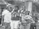  ?? GREG LOVETT/THE PALM BEACH POST ?? Cardinal Newman’s Ta’Narie Locust waves during Senior Night on Oct. 20 in West Palm Beach.