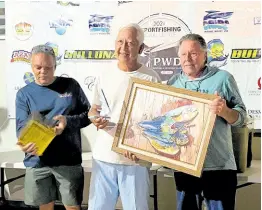  ?? PHOTO BY LENNOX ALDRED ?? Captain of the vessel ‘Freedom’ Wayne Chai Chong (centre) poses with Richard Foreman (left) and Jeremiah Healy at the prize-giving ceremony for the two-day PWD All-Species Fishing Tournament recently.