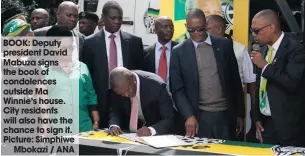  ??  ?? BOOK: Deputy president David Mabuza signs the book of condolence­s outside Ma Winnie’s house. City residents will also have the chance to sign it. Picture: Simphiwe
Mbokazi / ANA