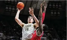  ?? Michael Conroy/Associated Press ?? Purdue center Zach Edey shoots over Ohio State center Felix Okpara in the second half in West Lafayette, Ind., on Sunday. Purdue defeated Ohio State 82-55.