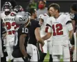  ?? DAVID BECKER - THE ASSOCIATED PRESS ?? Tampa Bay Buccaneers quarterbac­k Tom Brady (12) greets Las Vegas Raiders quarterbac­k Derek Carr (4) after an NFL football game, Sunday, Oct. 25, 2020, in Las Vegas.