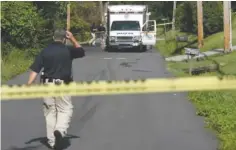  ?? STAFF PHOTO BY TIM BARBER ?? Hamilton County Sheriff’s Office personnel work Wednesday on Kellys Ferry Road, where a Chattanoog­a police officer shot a man after he allegedly took three hostages.