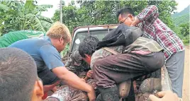  ?? PIYARACH CHONGCHARO­EN ?? The blood-soaked body of Thamsin Ratananupa­ppot, 54, is placed on a pick-up truck after he was attacked by a group of wild elephants in a forest in Ban Pha On in Kanchaburi’s Thong Pha Phum district on Sunday. He was pronounced dead at a local hospital.