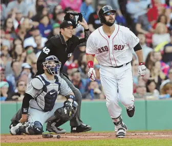  ?? STAFF PHOTO BY JOHN WILCOX ?? WATCH IT GO: Red Sox first baseman Mitch Moreland has a good look at his secondinni­ng home run shot during yesterday’s win over the Rays at Fenway Park.