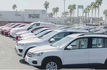  ??  ?? New and used Volkswagen vehicles are shown for sale at a Volkswagen car dealership in San Diego, California. “Should automobile sales go down, this could also hit suppliers and with them the whole economy.”