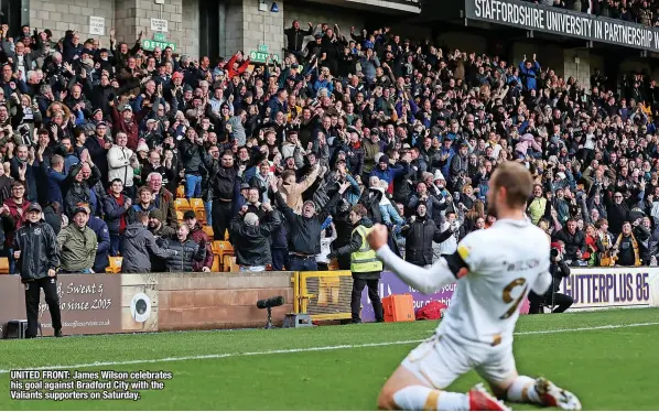  ?? ?? UNITED FRONT: James Wilson celebrates his goal against Bradford City with the Valiants supporters on Saturday.