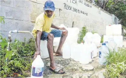  ?? NICHOLAS NUNES ?? Despite being a no-movement day, Paul Haslam makes use of the standpipe. He said that when there is no water in the homes, the pipe gets crowded with persons trying to get the commodity.