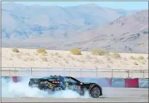  ??  ?? Schmidt roasts the tires in his modified Corvette Tuesday in Las Vegas. His license allows him to drive on Nevada roads in his specially modified Corvette, which requires no hands on its steering wheel or feet on its pedals. Schmidt uses head motions...