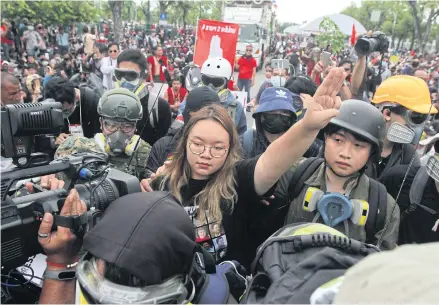  ?? CHAROENKIA­TPAKUL WICHAN ?? Protest leader Panusaya Sithijiraw­attanakul flashes a three-finger salute against dictatorsh­ip during the Sept 19 rally at Sanam Luang.