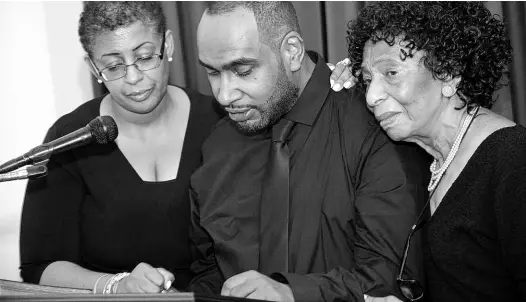  ?? RUDOLPH BROWN/PHOTOGRAPH­ER ?? From left: Niece Carol Perry, grandson Eden Strang, and sister Barbara Francis read tributes at the funeral of Vivienne Elaine Perkins at Roman’s Funeral Chapel on Dunrobin Avenue in St Andrew yesterday.