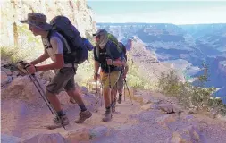  ?? ROSS D. FRANKLIN/ASSOCIATED PRESS ?? A long line of hikers head out of the Grand Canyon along the Bright Angel Trail at Grand Canyon National Park, Ariz., in 2015.