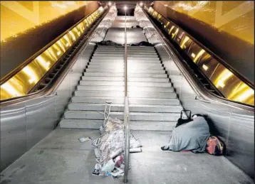  ?? Francine Orr Los Angeles Times ?? PEOPLE sleep at the Civic Center/Grand Park station. Metro has launched a one-year, $1.2-million contract that puts social workers on the Red Line five days a week to assist homeless riders.