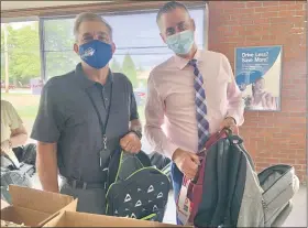  ??  ?? North Penn Superinten­dent Curt Dietrich, left, and Assistant Superinten­dent Todd Bauer hold backpacks filled with school supplies during the district Educationa­l Foundation’s third annual “Build-a-bag” drive.