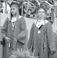  ?? MARK HUMPHREY ENTERPRISE-LEADER ?? Farmington seniors Camryn Journagan (left) and Javan Jowers await their diplomas during graduation ceremonies held Tuesday, May 15, at Cardinal Arena. Journagan graduated with some unfinished business. As a member of the high school softball team, she...