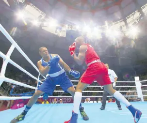 ?? FILE ?? Jamaica’s Ricardo ‘Big 12’ Brown (left) evades a punch thrown by Colombia’s Cristian Salcedo during the second round of their men’s heavy 91 kg semi-final boxing match at the Pan American Games in Lima, Peru, on Tuesday, July 30, 2019.