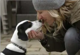  ??  ?? In this file photo Kate Fredette, of Waltham, Mass., greets the family dog, Roscoe, at their home in Waltham, Mass. The Fredette family found the dog through the online platform How I Met My Dog, that is designed to help humans pick the most compatible...