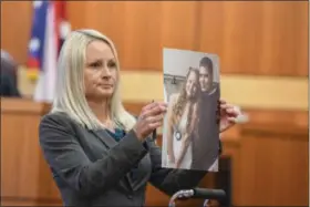  ?? ERIC BONZAR — THE MORNING JOURNAL ?? Lorain County Assistant Prosecutor Donna Freeman shows the jury a photo of 25-yearold victim Jeffrey Brooks and his fiance, Kayla Ellis, 24, during opening statements March 20. Nicholas D. Masley, 27, of Elyria, is on trial in the murder of Brooks.