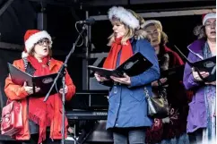  ??  ?? Kendall Harding (left) sings carols with other members of the Rochester Choral Society.