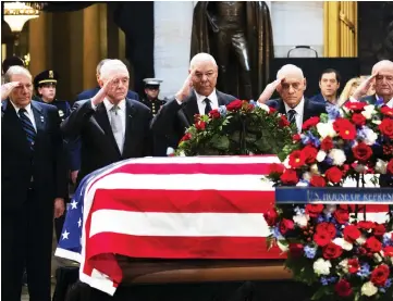  ?? — AFP photo ?? Former Chairman of the Joint Chiefs of Staff and former Secretary of State Colin Powell (centre) and former military officials from the Gulf War salute the casket of the late Bush.