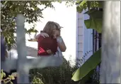  ?? CHRIS SEWARD — THE ASSOCIATED PRESS ?? Neighbors embrace at Castle Pines Drive and Sahalee Way in Raleigh, N.C., on Friday following a shooting rampage on Thursday night.