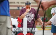  ?? AP PHOTO BY STEVE GONZALES ?? Santa Fe resident, Lori Simmons cries during a moment of silence in front of Santa Fe High School Monday, May 21, in Santa Fe.