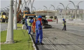  ?? ?? Labourers work on a project to upgrade Doha’s Corniche before the World Cup. Thousands are being sent home years before their contract ends. Photograph: Pete Pattisson/The Guardian