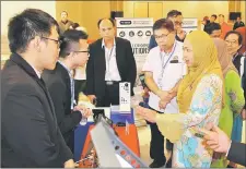  ??  ?? Dr Jamilah (right) takes a tour of the exhibition booths at the ‘Sarawak Pharmacy Conference 2019’.