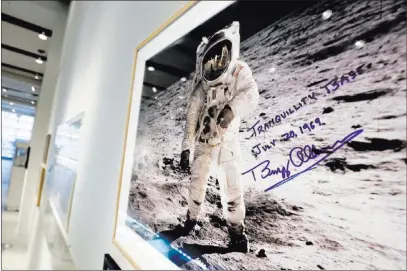  ?? Richard Drew ?? The Associated Press A print of astronaut Neil Armstrong’s photo of fellow Apollo 11 astronaut “Buzz” Aldrin standing on the moon, to be offered at auction at Sotheby’s, is displayed Thursday in New York. The photo, autographe­d by Aldrin, is estimated...