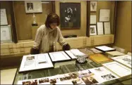  ?? TED S. WARREN - THE ASSOCIATED PRESS ?? FILE - In this Dec. 10, 2001 file photo Linda Johnson Rice, president and chief operating officer of Jet magazine, looks over awards and recognitio­ns won by the magazine in its 50-year lifetime at Jet’s Chicago headquarte­rs.