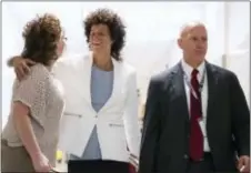  ?? MATT ROURKE — THE ASSOCIATED PRESS ?? Andrea Constand, center, hugs a person as she walks to the courtroom for Bill Cosby’s sexual assault trial at the Montgomery County Courthouse in Norristown, Pa.