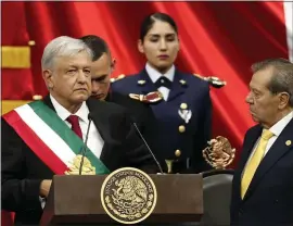  ?? EDUARDO VERDUGO — THE ASSOCIATED PRESS ?? Mexico’s new President Andres Manuel Lopez Obrador receives the presidenti­al sash.