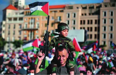  ??  ?? Partidario­s de Hamás salieron ayer a las calles con sus hijos armados con rifles