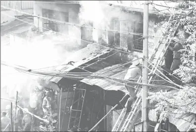  ?? (AP) ?? Indian firemen try to douse a fire that broke out early morning at an illegal six-story plastics market in Kolkata, India, on Feb 27. The fire was under control but toxic gases being released by the blaze were hampering rescue efforts. More than a...