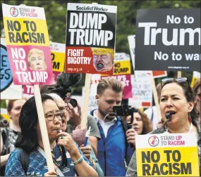  ?? Jack Taylor / Getty Images ?? Protesters chant and wave placards during a demonstrat­ion outside Winfield House, the London residence of U.S. ambassador Woody Johnson, where President Donald Trump and First Lady Melania Trump stayed Thursday night.