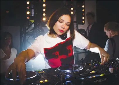  ?? DEIDRE SCHOOL / THE NEW YORK TIMES FILE (2017) ?? Nina Kraviz plays a set at the Calvin Klein party in September during New York Fashion Week. A growing network of booking agencies and community groups have made female DJS more visible in Berlin, arguably the world capital of undergroun­d electronic...