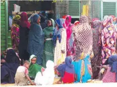  ?? — AFP ?? People stand in a queue on Wednesday outside a bakery in the central Sudanese city of Al Obeid.