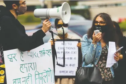  ?? JOHN KENNEY ?? Community organizer Amy Darwish of the Comité d’action de Parc-extension speaks prior to the departure of a caravan of Park Extension residents, who took to the streets by car and by bicycle Saturday to call attention to a housing crisis in the area.