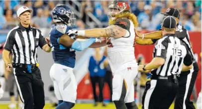  ?? THE ASSOCIATED PRESS ?? Officials break up Tennessee Titans linebacker Jayon Brown, left, and Tampa Bay Buccaneers offensive guard Ryan Jensen, right, in the first half of Saturday’s preseason game in Nashville.