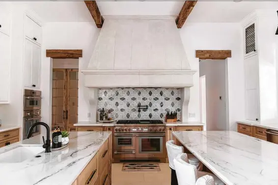  ?? Photos by Melissa Parsons Photograph­y ?? Both islands in Nikki and GregWalley’s kitchen are topped with natural quartzite, installed waterfall style down each side.