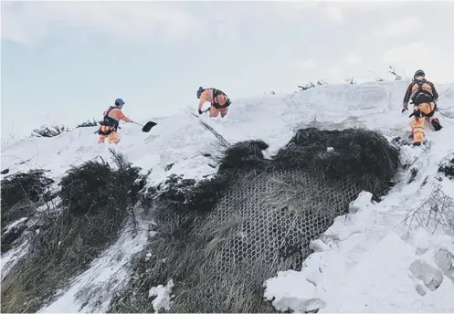  ?? PICTURE: SCOTRAIL ALLIANCE ?? Teams of abseilers worked in shifts for 20 hours to shift the overhangin­g snow from the top of the cutting