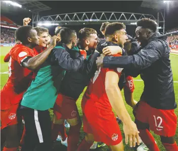  ?? COLE BURSTON/THE CANADIAN PRESS ?? Forward Lucas Cavallini, second from right, celebrates with teammates after Cavallini scored in Canada’s 2-0 win over the U.S. last month, Canada’s first triumph over the U.S. since 1985.