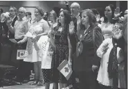  ?? ADINA BRESGE / THE CANADIAN PRESS ?? Newcomers take the citizenshi­p oath in Halifax in July. A 13% increase in immigrants by 2020 represents the highest intake since before the First World War.