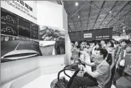  ?? TAO LIANG / XINHUA ?? Staff of a 5G technology company demonstrat­e long-distance assisted autonomous vehicle driving to visitors at the Big Data Expo in Guiyang, Guizhou province, on May 26.