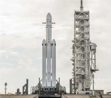  ?? SPACEX VIA THE NEW YORK TIMES ?? SpaceX’s Falcon Heavy will be carrying Elon Musk’s cherry-red Tesla Roadster within its 140,000-pound capacity.