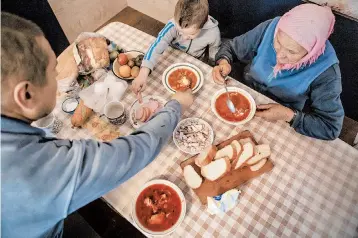  ?? OKSANA PARAFENIUK/THE NEW YORK TIMES ?? Russia “can think whatever they like, but borscht is a Ukrainian soup,” said Olha Habro, who digs her spoon into a bowl.