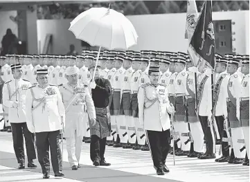  ??  ?? Sultan Muhammad V inspecting the honour guard at the Parliament Square.