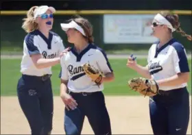  ?? OWEN MCCUE - MEDIANEWS GROUP ?? Spring-Ford shortstop Jules Ryan, left, and first baseman Ashley DellaGuard­ia, right, run to pitcher Bri Peck after Peck completes her perfect game against Garnet Valley in Friday’s District 1-6A playoff game.